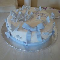 Butterfly Farewell Cake Covered in fondant and fondant butterflies and bow.