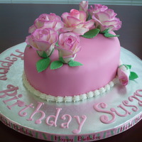 Rose Birthday Cake Strawberry cake with buttercream icing and covered in fondant. Roses are gumpaste.