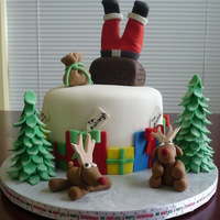 Santa Cake Chocolate fudge cake with peanut butter buttercream filling and covered with chocolate icing and fondant. All accents are fondant/gumpaste...