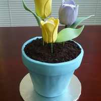 Flower Pot Cake With Tulips Flower pot is pound cake covered with buttercream and fondant. Dirt is crushed Oreos. Flowers are marshmellows covered with buttercream and...