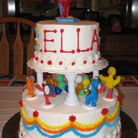 Elmo Birthday Cake Two-tier buttercream icing cake with Elmo figurines