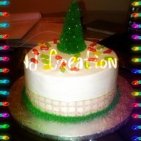 Christmas Tree the tree was made with an icecream cone covered with royal icing. the cake is covered with frosting, jelly beans and a ribbon cut to...