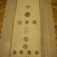 Wii Remote I cute a half sheet in half and stacked, iced with buttercream. Buttons are gumpaste.