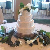 "spackled And Scrolled" Wedding Cake Buttercream "spacked" on round French vanilla tiers with scrolling in in front. Fresh lilies were found in a bucket near the set-...