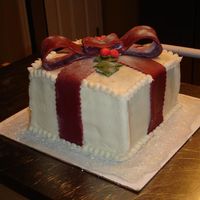 Christmas Cake Christmas Cake with buttercream icing and fondant bow. I used the paint roller method with the crusting buttercream.