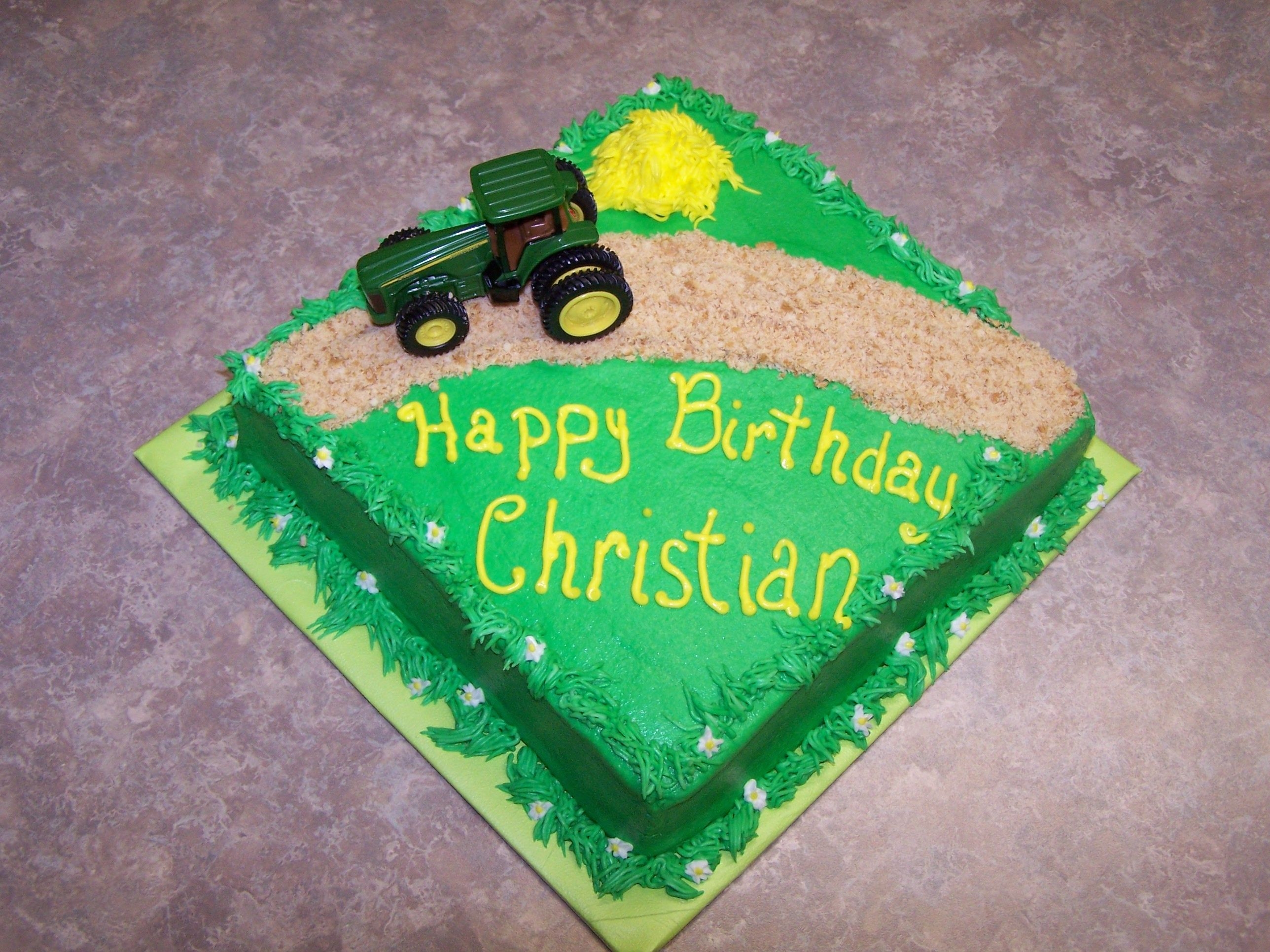 Farm 8" square white cake w/ bc. Road is graham crackers. Tractor is a toy.