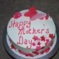 Flowers And Butterflies 8" round strawberry cake with strawberry filling and bc icing. Flowers and butterflies are fondant.