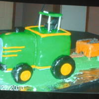 Big Green Tractor I REALLY ENJOYED MAKING THIS CAKE. IT WAS FOR A FRIEND'S SON'S FIRST BIRTHDAY. ON THE TRAILER IS THE ONE YEAR OLD CAKE (BALE OF...