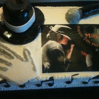 Michael Jackson All edible, fondant and rice krispie hat, chocolate and white cake with buttercream icing. Hand painted hat, notes, and mike.