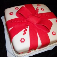 Wilton Course 3 - First Cake My first attempt at a fondant cake from the Wilton Course 3. FAR from perfect, but it's a start at least. ;-)