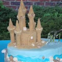 Beach/ocean Wedding Cake for my cousin who married at beach and had reception 2 wks later at home. Half red velvet, half yellow w/ strawberry filling. Covered in...