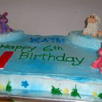 Webkinz Cake Lemon cake w/ lemon curd filling. Iced in 7-minute frosting - airbrushed blue. Figures are gumpaste modeled after her favorite Webkinz