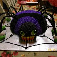 It's A Spider! Spider is done with buttercream frosting and legs are licorice whips and teeth are candy corn.