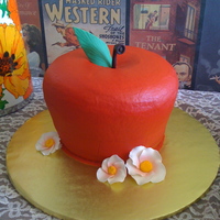 Apple Cake A three layer spice pound cake. Iced in buttercream, leaf and stem are fondant, flowers are gumpaste.