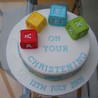 Christening Cake - Building Blocks This was a cake that I made for my friend's sons christening. I used stencils for the feet with royal icing.