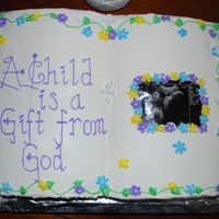 A Child Is A Blessing From God My friend wanted a religious type cake for her baby shower so I made this using the book cake pan from Wilton. Home made buttercream recipe...