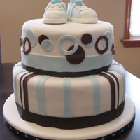 Baby Shower Cake Blue and brown Baby Shower cake with baby shoe topper. Thank you to Stellastarchild for the template for the baby shoes. Cake is WASC with...