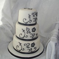 Black And White Scroll 6", 8", 10" WASC with IMBC and fondant overlay. Black scroll with silver dragees and real satin black ribbon. TFL!
