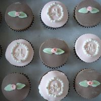 Confirmation Cupcakes combination chocolate and vanilla cupcakes with cream filling and fondant decor. The guest wanted this design. The brown was hard to...