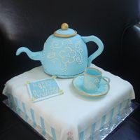 Teapot Cake I made this for an 86 year old lady's birthday. The teapot is chocolate with strawberry cream filling and fondant and gumpaste decor....