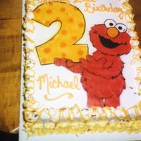 Birthday With Elmo The cake design was taken from a birthday card. I outlined the picture, then used an airbrush to fill it in. The little one loved it!