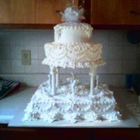 Dancing Cherubs This cake is a 16" square with a 12" and and 8" tier on top. This cake serves approximately 200. It was done with...