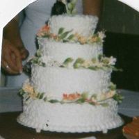 Crooked Delight This was my first attempt at a "crooked" design. The bottom layers should have been more angled. I arranged gum paste flowers...