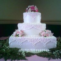 Elegantly Pink The cake sizes are a 14" square cake with a 10" and a 6" round on top. This cake will serve 125. It was iced with a non-...