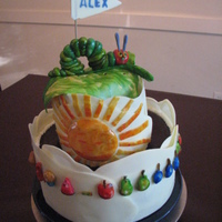 The Very Hungry Caterpillar Baby Shower Cake - Tiramisu cake sleeved in white chocolate with painted fondant decorations.