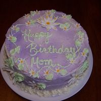 Moms Birthday Cake White cake with raspberry filling. Buttercream icing with fondant flowers