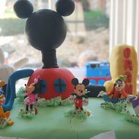 Mickey Mouse Club House Main Cake & Clubhouse dome all Victoria Sponge covered in fondant, Foot is RKT covered in Fondant, hand is all fondant (in hindsight...