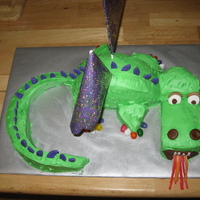Dragon Cake Used two 8" pan. cut one half in the middle to make the body and used the other half to make tail, head and paws. details are mostly...