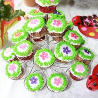 Cup Cakes With Flowers Cup cakes with buttercream icing and the little flowers are fondant.