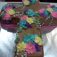 God Bless You Cross This cake was made for a friends Baptisim. Chocolate cake with ganache filling and Chocolate Butttercream Icing.