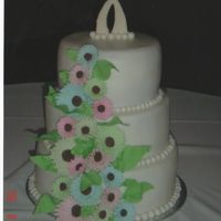 Gerber Daisy Wedding Cake 3 tier double -layered cakes,buttercream icing, rolled fondant balls around each layer, choc. transfer topper and gumpaste gerber daisies...