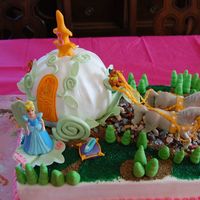 Cinderella Carriage Cake 11 by 14 base, ball pan for the carriage.Buttercrean icing,fondant treess,slipper and pillow with gumpaste accessories on the carriage....