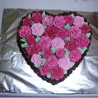Rose Cake Chocolate cake with roses of different colors covering the top of the cake.