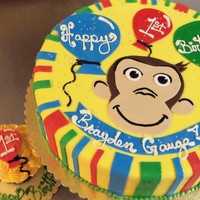 Curious? First Birthday Cake to match curious george Party supplies, fiinished with rolled fondant accents.