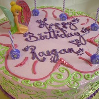 Tinkerbell Simply Sweet 12" round Butter Cream cake accented with lime green scroll work, glitter and finished with a Tinkerbell Candle.