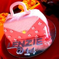 Give Me That Bag this is carved caked from a 9" round cake, a cake for a 14 year old girl..choc. pound cake with ganache filling finished with fondant...