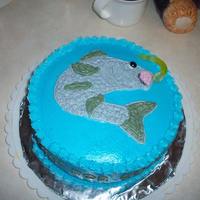 Gone Fishing For Good! All buttercream (except gummy worm). The side of the cake reads: Gone fishin' for good! We will miss you!