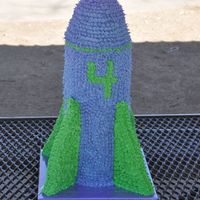 Rocket Cake Rocket cake, made of 9 layers of strawberry cake. Top layer was carved to make dome. "Wings" are rice crispy treat. Cake was...
