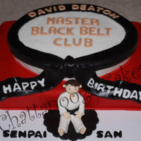 Karate Birthday Cake Made this cake to match a badge the young man won in his Karate Class....at least the top layer matches :-) The red layer is supposed to...
