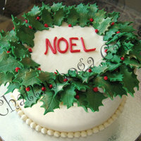 Christmas Wreath Cake Christmas Wreath for a customer. Vanilla/Almond cake with buttercream frosting and fondant holly leaves dusted with gold luster.