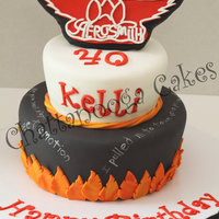 Aerosmith Cake My customer requested an Aerosmith themed cake...she wanted the logo standing up on top and some of the lyrics to Sweet Emotion written on...