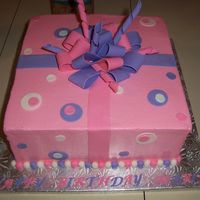 Present Cake This is a Chocolate and Vanilla cake with "cookies and creme" center. It is a huge soft baked choc. chip cookie w/ buttercream...