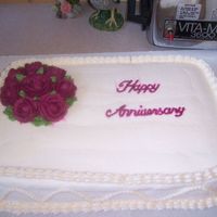 My Parents Anniversary Cake Made while I was taking Wilton course 1.My parents 40th wedding anniversary.Ivory buttercream with burgandy roses.