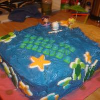 Side View Of Daughters Birthday Cake I went really easy by purchasing the decorations. The sand is crushed grahm crackers. It was pretty easy. It was supposed to have palms but...