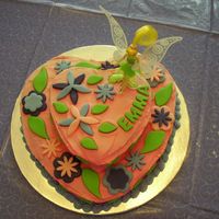 Tinkerbell Cake Royal icing covered in fondant flowers and leaves. I used a little Tinkerbell doll as the topper.