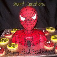 Spiderman Loved making this cake. Covered in fondant and airbrushed to get the red color. Piped on the web design and added super hero cookies